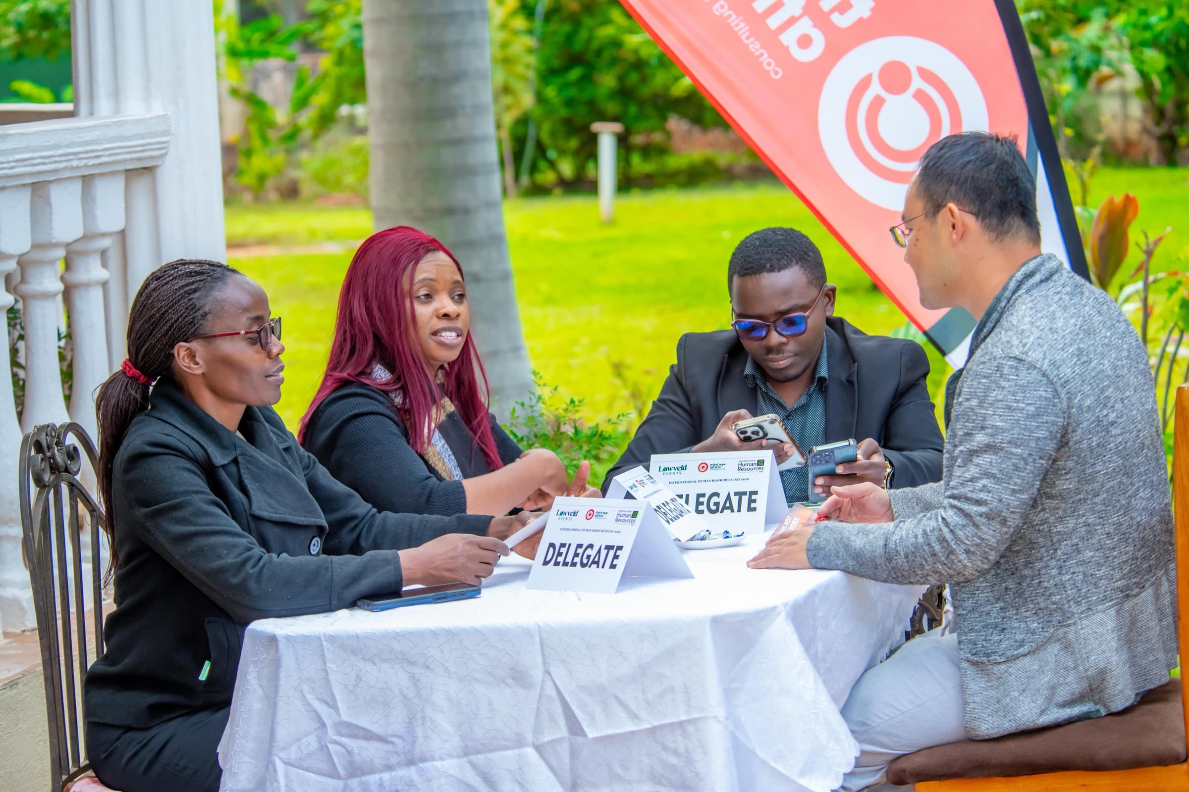 Delegates registering at an outdoor table beside a 3rd Eye Africa banner