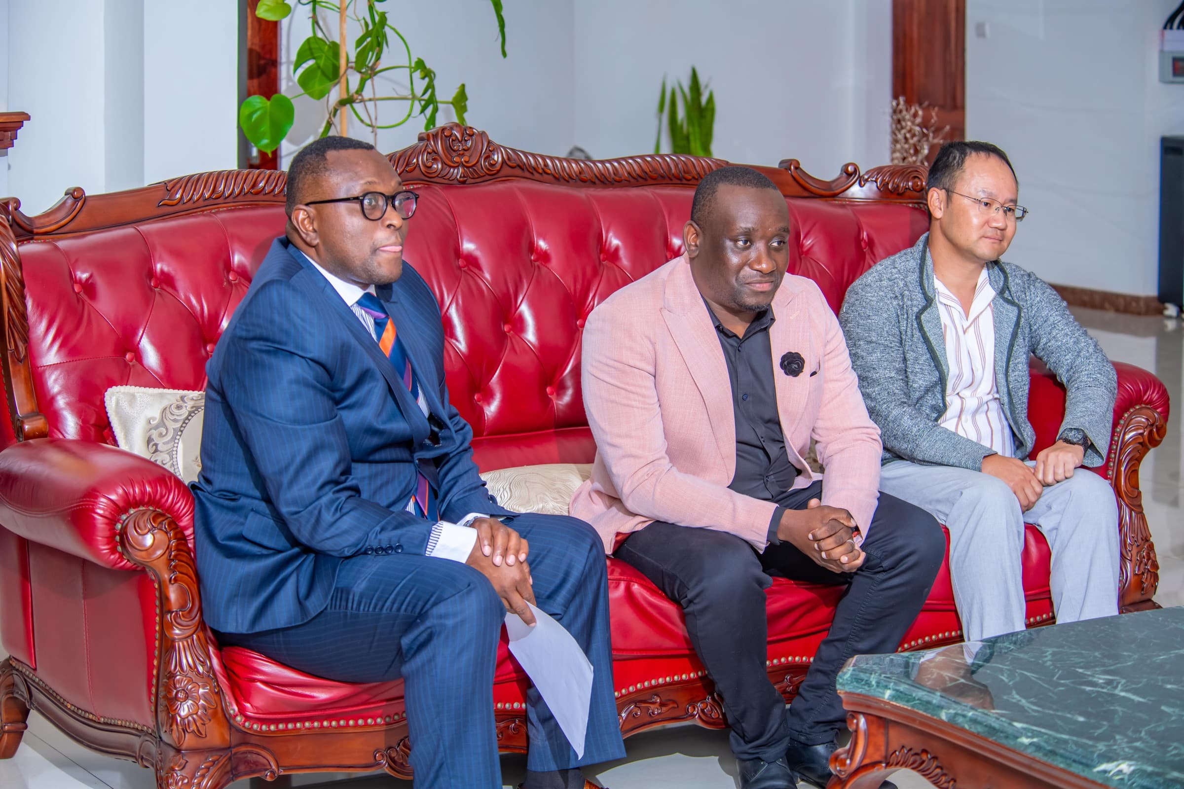 Panellists seated on a red sofa during a leadership conversation