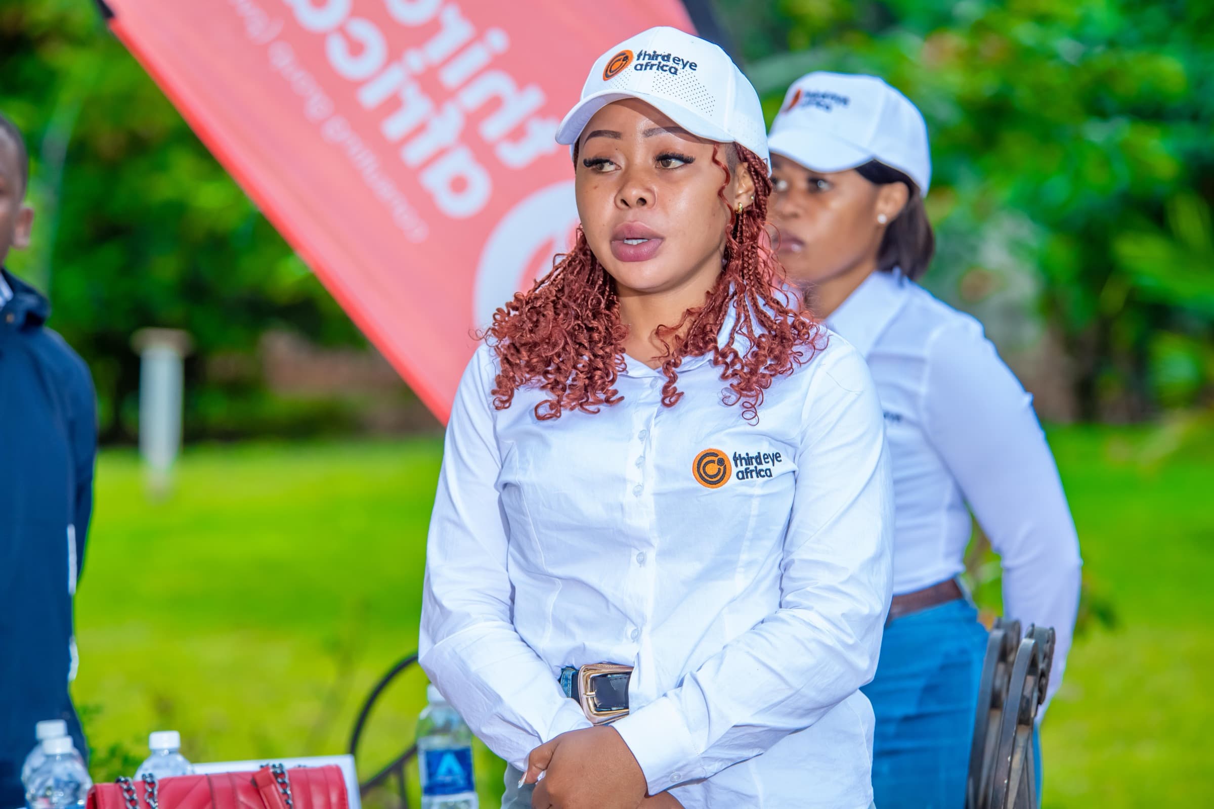 3rd Eye Africa team members in branded caps and shirts
