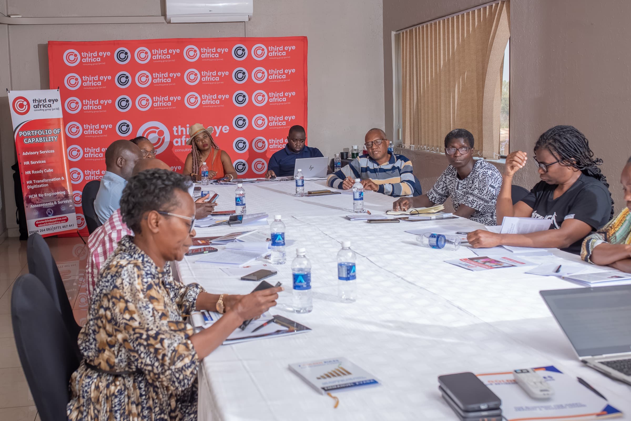 Participants seated around a boardroom table during a workshop